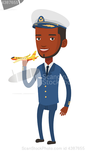 Image of Cheerful airline pilot with model of airplane.