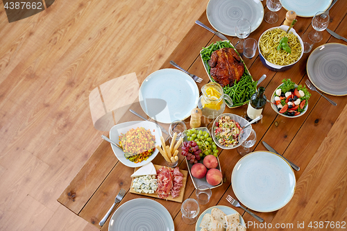 Image of various food on served wooden table