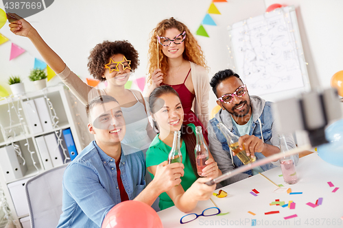 Image of happy team taking selfie at office party