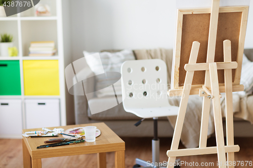 Image of easel and artistic tools at home or art studio