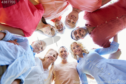 Image of happy family looking down standing in circle