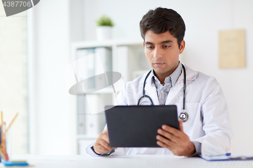 Image of doctor with tablet pc and stethoscope at clinic