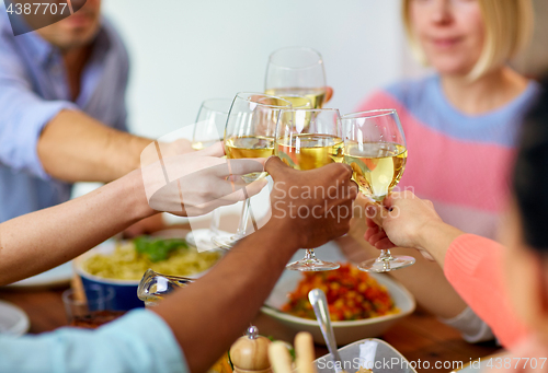 Image of hands clinking wine glasses