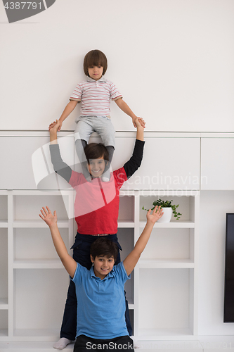 Image of young boys posing line up piggyback