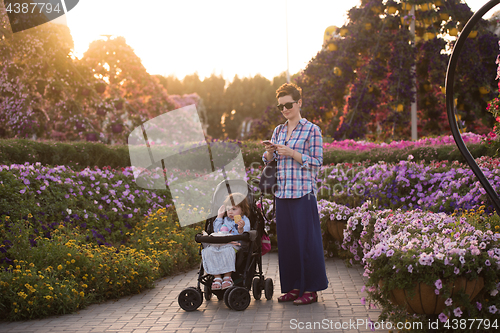 Image of mother and daughter in flower garden