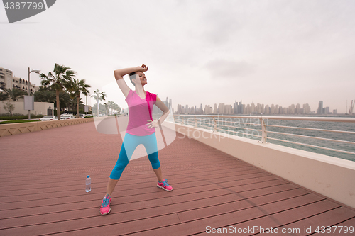 Image of woman stretching and warming up