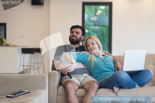Image of young happy couple relaxes in the living room