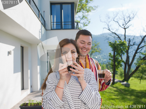 Image of Young beautiful couple in bathrobes