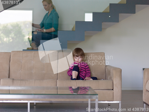 Image of little girl playing games on smartphone