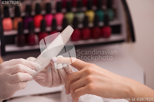 Image of Woman hands receiving a manicure