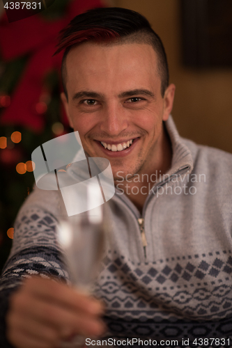 Image of Happy young man with a glass of champagne