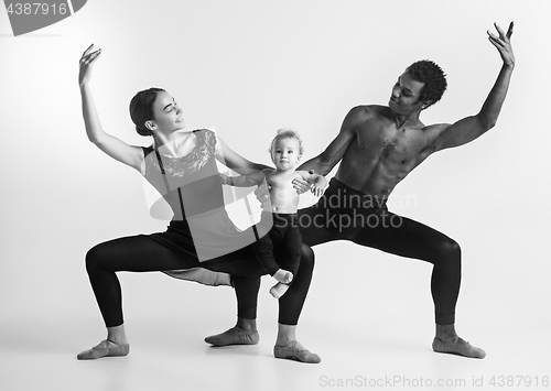 Image of A happy family of ballet dancers on white studio background