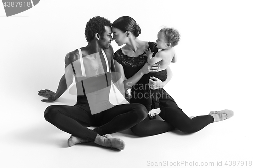 Image of A happy family of ballet dancers on white studio background