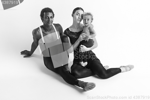 Image of A happy family of ballet dancers on white studio background