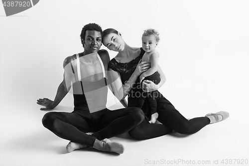 Image of A happy family of ballet dancers on white studio background