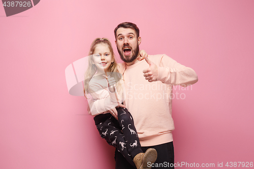 Image of Young father with his baby daughter with thumb up