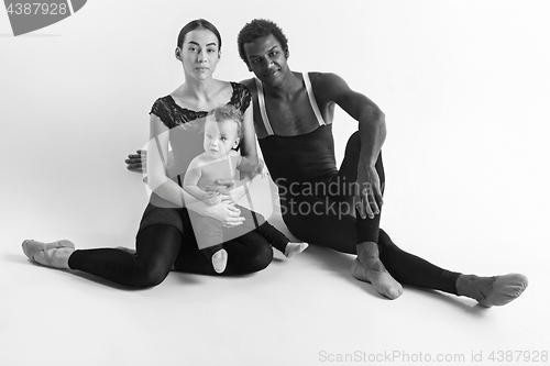 Image of A happy family of ballet dancers on white studio background