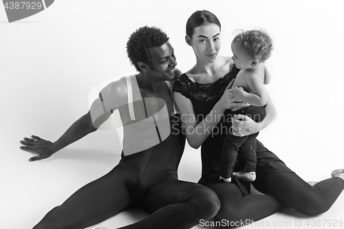 Image of A happy family of ballet dancers on white studio background