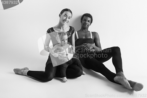 Image of A happy family of ballet dancers on white studio background