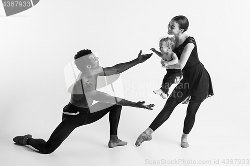 Image of A happy family of ballet dancers on white studio background