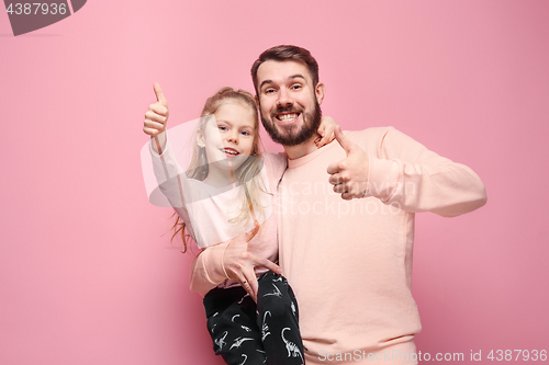 Image of Young father with his baby daughter with thumb up