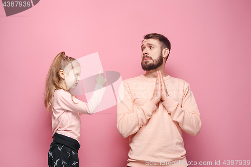 Image of Young father with his baby daughter. The kid in preschool age pointing with finger