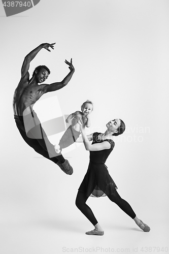 Image of A happy family of ballet dancers on white studio background