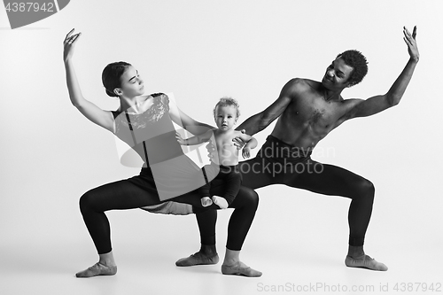 Image of A happy family of ballet dancers on white studio background