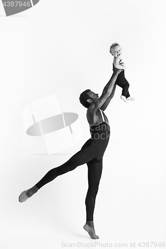 Image of A happy family of ballet dancers on white studio background