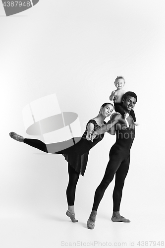 Image of A happy family of ballet dancers on white studio background