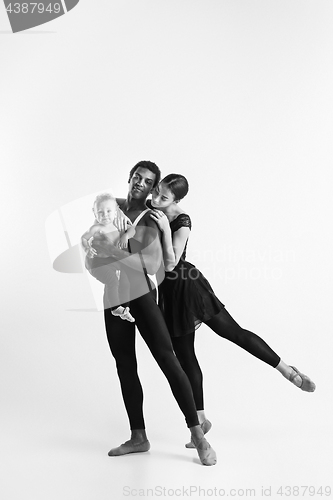 Image of A happy family of ballet dancers on white studio background