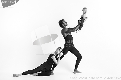 Image of A happy family of ballet dancers on white studio background