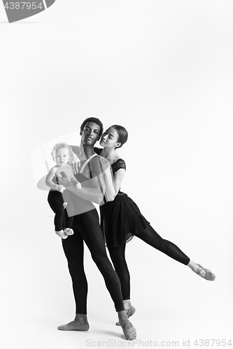 Image of A happy family of ballet dancers on white studio background