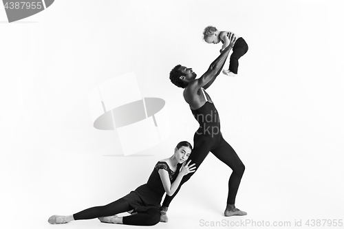 Image of A happy family of ballet dancers on white studio background