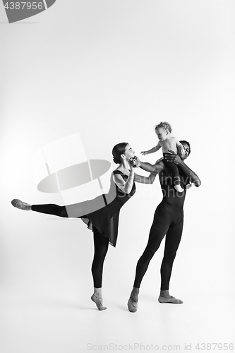 Image of A happy family of ballet dancers on white studio background