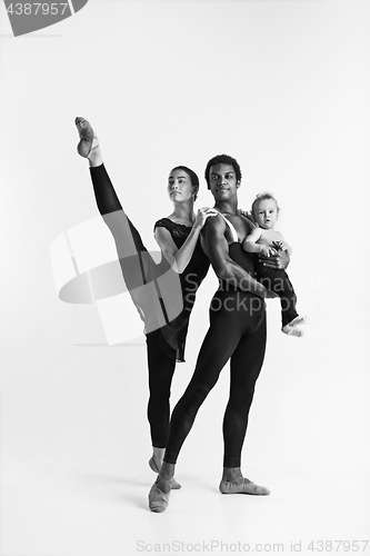 Image of A happy family of ballet dancers on white studio background