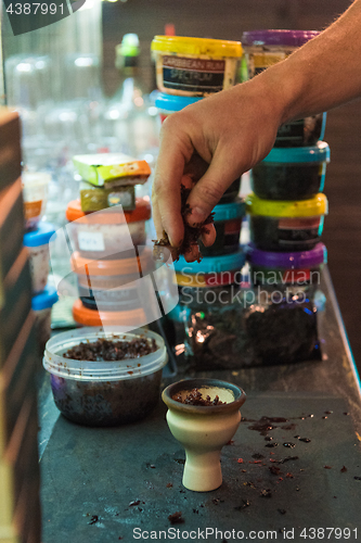 Image of Shisha hookah preparing by barman.