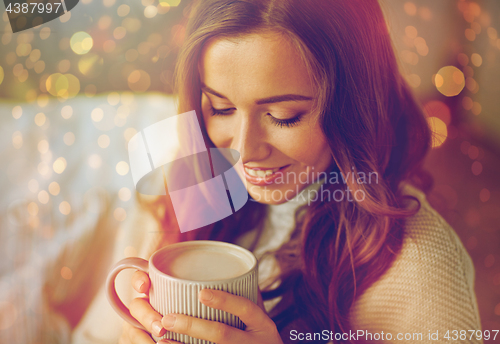 Image of close up of woman drinking cocoa at christmas