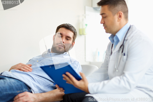 Image of doctor and man with health problem at hospital