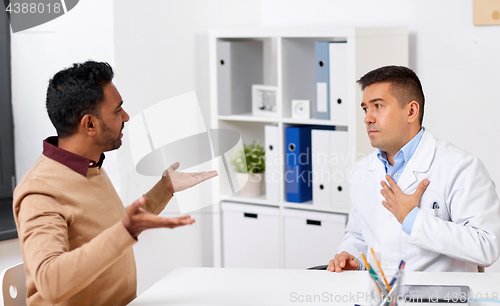 Image of doctor and displeased male patient argue at clinic