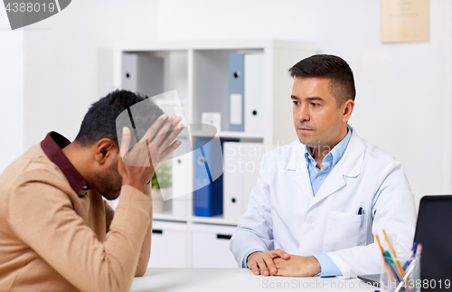 Image of doctor and unhappy male patient at hospital