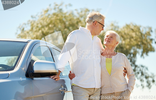 Image of happy senior couple at car in summer