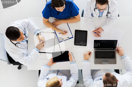 Image of doctors with cardiogram and computers at hospital