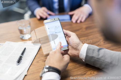 Image of Close up of businessman using mobile smart phone.