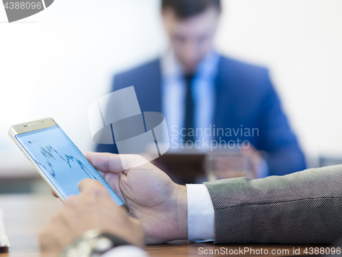 Image of Close up of businessman using mobile smart phone.