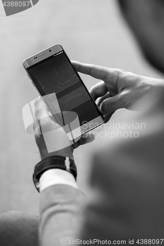 Image of Close up of businessman using mobile smart phone.