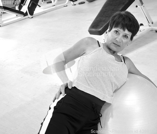 Image of Sitting on yoga ball.