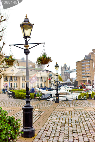 Image of Old lantern and yachts in St Katharine Docks