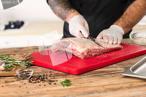 Image of Man cooking meat steak on kitchen