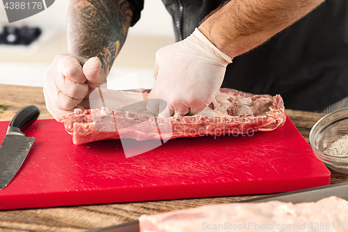 Image of Man cooking meat steak on kitchen